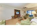 Cozy living room featuring a television, lounge chair and sliding glass door at 6108 7Th W Ave # 6108, Bradenton, FL 34209