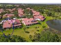 Lush backyard views showing mature landscaping, red tile roof, and serene atmosphere at 7331 Villa D Este Dr, Sarasota, FL 34238
