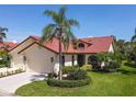 Charming home featuring a well-manicured lawn and lush tropical landscaping at 7331 Villa D Este Dr, Sarasota, FL 34238