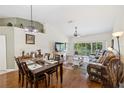 Spacious living room with hardwood floors, high ceilings, and access to balcony at 7532 Marsh Orchid Cir # 8-201, Bradenton, FL 34203