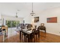 Open-concept living and dining room with hardwood floors and views to the balcony at 7532 Marsh Orchid Cir # 8-201, Bradenton, FL 34203