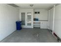 Spacious garage with double doors, built-in shelving, and ample storage space at 754 Spanish S Dr # 754, Longboat Key, FL 34228