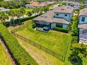 Expansive fenced backyard featuring a screened lanai with a hot tub, perfect for outdoor entertaining at 8272 Summer Night Rd, Sarasota, FL 34241