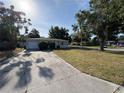 A cozy single-story home with a driveway and green space, perfect for suburban living at 8291 57Th N St, Pinellas Park, FL 33781