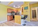 Bright kitchen featuring wood cabinets, stainless steel appliances, and breakfast bar seating at 8341 38Th Street Cir E # 303, Sarasota, FL 34243