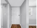 Entryway featuring wood floors and a large white door at 9393 Midnight Pass Rd # 603, Sarasota, FL 34242