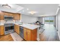 Open kitchen design with stainless appliances and views of the dining and living areas at 9393 Midnight Pass Rd # 603, Sarasota, FL 34242