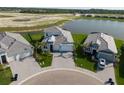 Picture of homes in a residential area with well-maintained landscaping and a lake in the background at 10030 Degas Ter, Bradenton, FL 34212