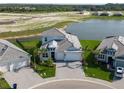 Overhead view showcasing a landscaped home near a lake, part of a residential community at 10030 Degas Ter, Bradenton, FL 34212