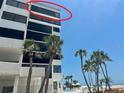 Exterior shot of condo building showing a partial ocean view from the building's balcony at 1100 Benjamin Franklin Dr # 802, Sarasota, FL 34236