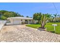 Inviting single-story home featuring a brick driveway and well-kept lawn at 1324 Augusta S Ln, St Petersburg, FL 33707