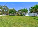 Quaint home with expansive lawn, complemented by lush tropical landscaping at 1324 Augusta S Ln, St Petersburg, FL 33707