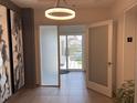 Elegant hallway with art and natural light leads to a balcony with outdoor seating, unit number three at 1345 2Nd St, Sarasota, FL 34236