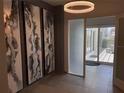Inviting hallway with decorative art leading to a bright balcony space with outdoor seating at 1345 2Nd St, Sarasota, FL 34236