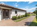 Inviting home entrance with brick pavers and landscaped garden at 15752 Sacile Ln, Bradenton, FL 34211