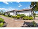 Lovely home exterior featuring a tile roof, lush landscaping and a brick walkway at 15752 Sacile Ln, Bradenton, FL 34211