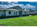 Well-manicured front yard featuring healthy green grass and neatly trimmed perimeter shrubs at 1612 Fairway Oaks Dr, Palmetto, FL 34221