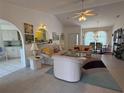 Spacious living room with tile floors, vaulted ceilings, and open floor plan flowing into dining area at 21498 Beaverton Ave, Port Charlotte, FL 33952