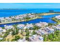 Scenic aerial of a coastal community, showcasing a mix of stylish homes, serene lake and access to the open ocean at 262 Sapphire Lake Dr # 202, Bradenton, FL 34209