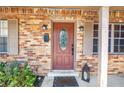 A beautiful brick entrance featuring a decorative glass front door and covered porch at 3311 Florida Blvd, Bradenton, FL 34207