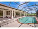 Large screened-in pool area featuring a spacious patio, perfect for lounging and enjoying the outdoors year-round at 3388 Highlands Bridge Rd, Sarasota, FL 34235