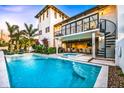 Gorgeous pool and spa with an outdoor kitchen, bar area, and a spiral staircase at 340 Jackson Dr, Sarasota, FL 34236