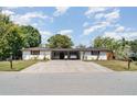 Charming single-story home with a spacious driveway and well-maintained landscaping at 3921 Marlborough Pl, Sarasota, FL 34241