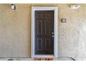 A warm and inviting exterior front door with decorative hardware and modern accents at 4061 Crockers Lake Blvd # 27, Sarasota, FL 34238