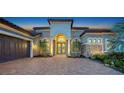 Charming home exterior showcasing a paved driveway, attached garage, and a decorative archway entrance at 4809 Benito Ct, Bradenton, FL 34211