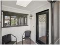 Inviting entryway with a decorative glass door, tiled floor, and chair seating at 532 Oak Hill Cir # 12, Sarasota, FL 34232