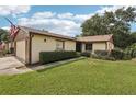 Well maintained single-story home featuring a beautiful lawn and mature landscaping at 532 Oak Hill Cir # 12, Sarasota, FL 34232