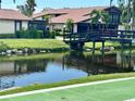 Exterior landscape view showing home and bridge leading to a beautiful pond at 5400 34Th W St # H12, Bradenton, FL 34210