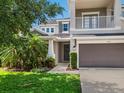 Charming two-story home featuring a well-kept lawn, inviting entrance, and a two-car garage at 5709 Wild Sage Cir, Sarasota, FL 34238