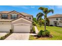 A townhome with a two-car garage, beautiful stone accents, mature landscaping, and a brick-paver walkway at 5843 Wake Forest Run # 104, Bradenton, FL 34211
