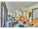 Screened in patio provides comfortable seating next to door at 6501 Mourning Dove Dr # 215, Bradenton, FL 34210