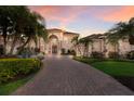 Inviting front facade with manicured landscaping and a spacious brick driveway at 801 3Rd E St, Palmetto, FL 34221