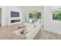 Cozy living room with sleek fireplace, comfortable seating, and sliding doors to the outdoor patio at 8069 Tidal Pointe Way, Sarasota, FL 34240