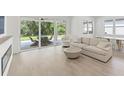 Bright living room features comfortable seating with an outdoor patio beyond the sliding glass doors at 8069 Tidal Pointe Way, Sarasota, FL 34240