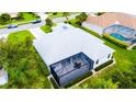 Aerial view of the home with a screened lanai and well-maintained landscaping, providing privacy and beauty at 8979 Grey Oaks Ave, Sarasota, FL 34238