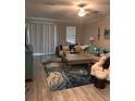 Bright living room with a stylish rug, comfortable seating, and large windows providing natural light at 9808 Campanula Ct, Land O Lakes, FL 34637