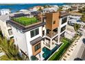 Luxury coastal home featuring a rooftop terrace with artificial turf and great views of the water at 100 6Th S St, Bradenton Beach, FL 34217