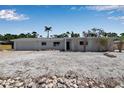 Charming single-story home with a garage and a landscaped front yard featuring decorative stones at 130 N Adams Dr, Sarasota, FL 34236