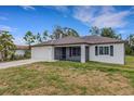 Inviting home exterior featuring a screened-in porch and attached two-car garage at 1370 Mccrory St, North Port, FL 34286