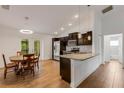 Modern kitchen with stainless steel appliances, wooden cabinets, and a cozy dining area at 1370 Mccrory St, North Port, FL 34286
