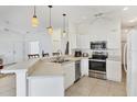 Bright kitchen with stainless steel appliances, modern countertops, and stylish pendant lighting at 1516 Red Oak Ln, Port Charlotte, FL 33948