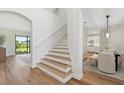 Bright entryway with wooden floors, staircase, and views to dining and living spaces at 15315 Golden Beam Pl, Bradenton, FL 34211