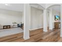 Spacious living room featuring hardwood floors, columns, and a neutral color scheme at 15315 Golden Beam Pl, Bradenton, FL 34211
