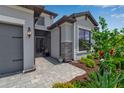 Close up of the front entrance featuring stone accents, meticulous landscaping, and a paved walkway at 15607 White Linen Dr, Bradenton, FL 34211