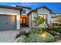 Close up of the front entrance featuring stone accents, meticulous landscaping, and a paved walkway at 15607 White Linen Dr, Bradenton, FL 34211