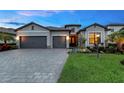 Charming single-story home with a three-car garage, paver driveway and walkway, and well-maintained landscaping at 15607 White Linen Dr, Bradenton, FL 34211